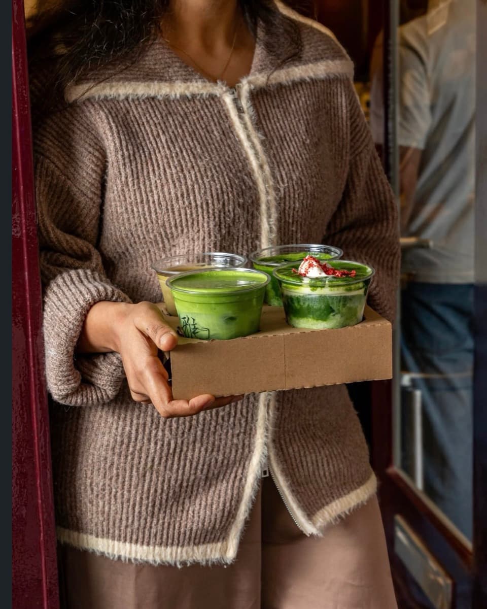 A tray of matcha drinks being carried out to a client on shoot day