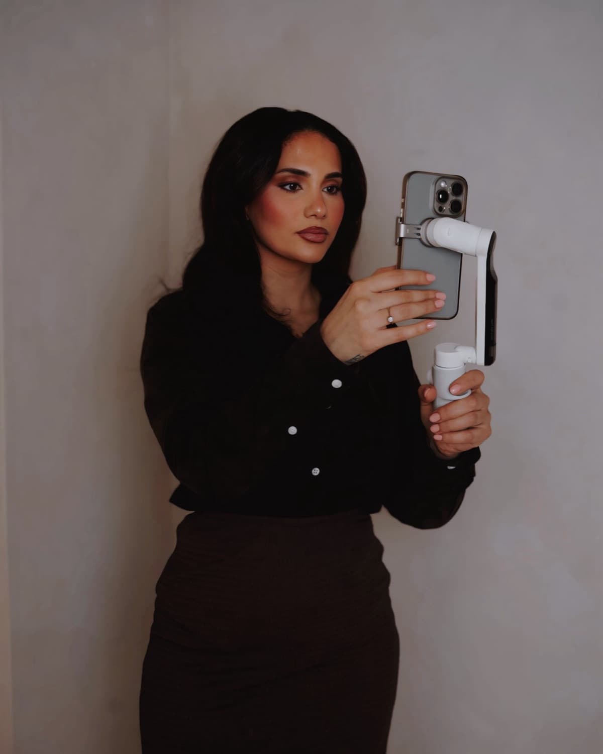 Amalin of Aria Socials filming on a phone mounted to a gimbal